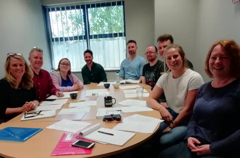 Group of BAP Disability Network members sitting round a table at a network meeting